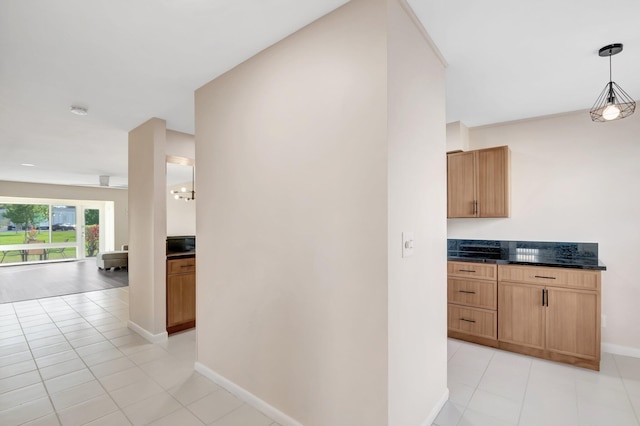 corridor with light tile patterned floors and baseboards