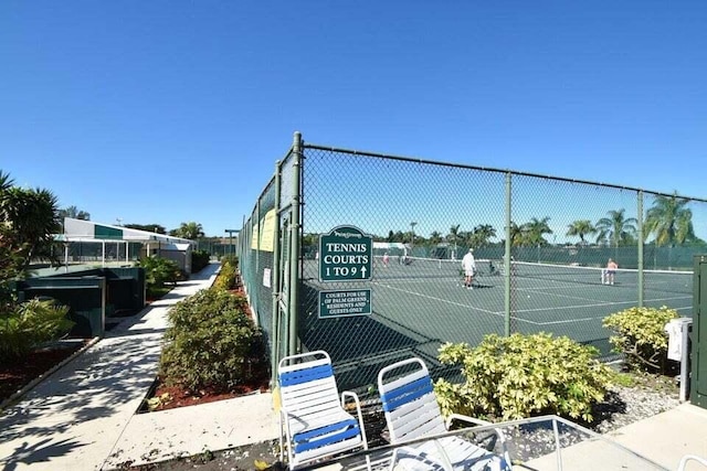 view of tennis court with fence