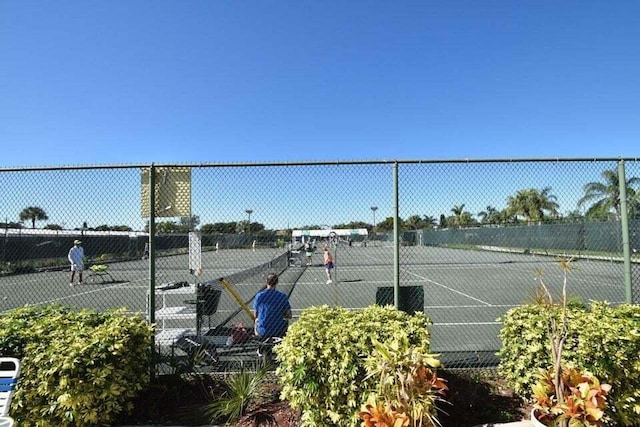 view of sport court featuring fence