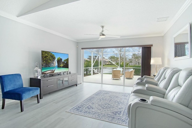 living room with light wood finished floors, visible vents, a ceiling fan, crown molding, and a textured ceiling