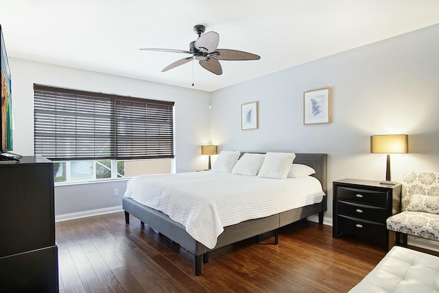 bedroom featuring a ceiling fan, baseboards, and wood finished floors