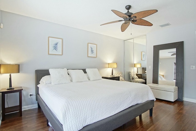 bedroom with wood finished floors, a ceiling fan, visible vents, baseboards, and a closet