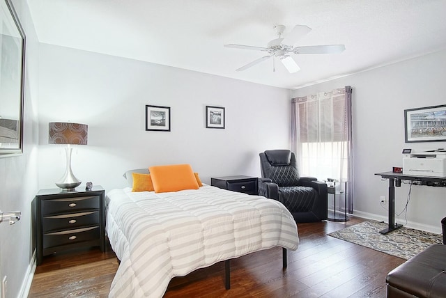 bedroom featuring ceiling fan, baseboards, and wood finished floors