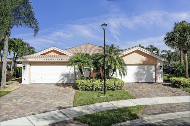 view of front of house featuring a tiled roof and stucco siding