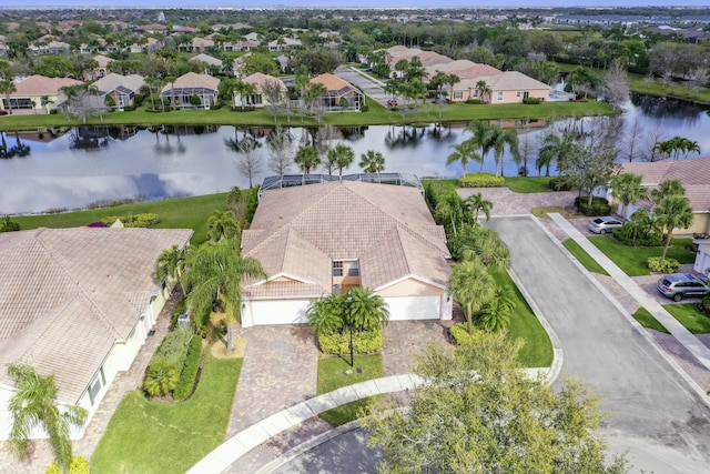 birds eye view of property featuring a water view and a residential view