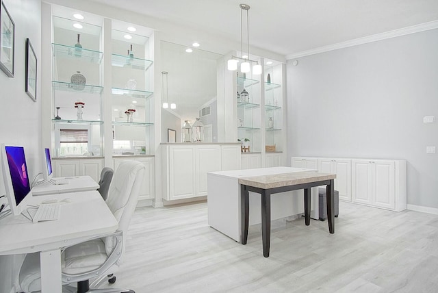 office space featuring ornamental molding, light wood-type flooring, visible vents, and baseboards