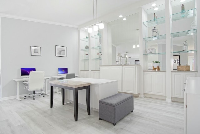 interior space featuring baseboards, decorative light fixtures, light wood-style flooring, and crown molding