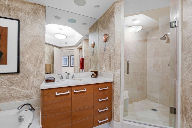 full bath with a garden tub, a shower stall, and vanity