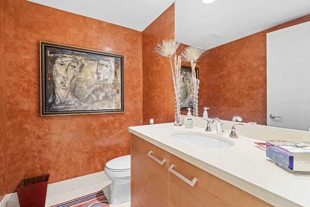 half bath featuring visible vents, baseboards, toilet, tile patterned flooring, and vanity