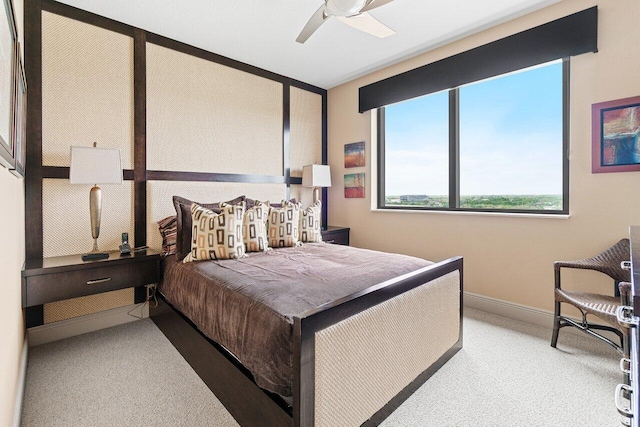 bedroom with carpet, ceiling fan, and baseboards