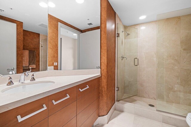 full bathroom featuring a stall shower, tile patterned flooring, visible vents, and vanity