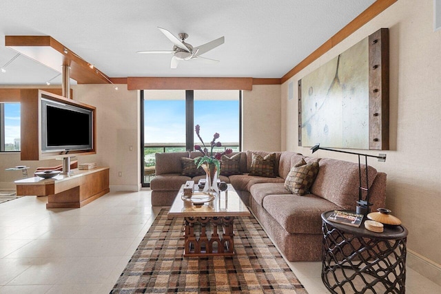 living room featuring light tile patterned floors, expansive windows, a ceiling fan, and baseboards