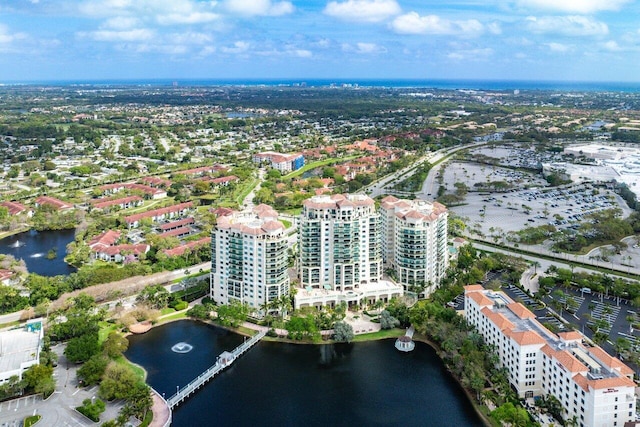 birds eye view of property with a view of city and a water view