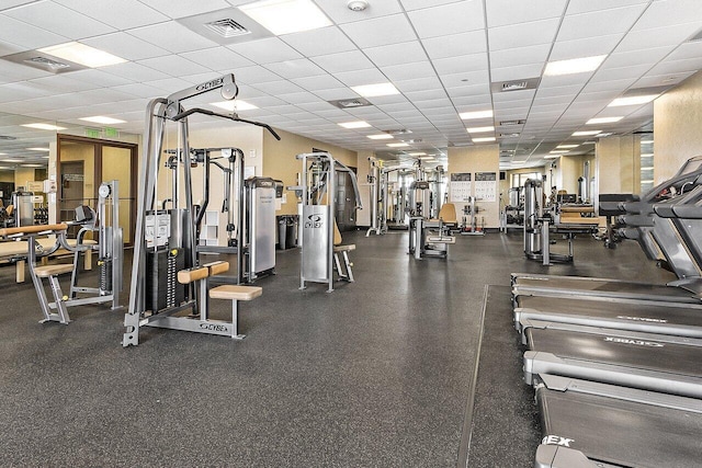 gym featuring visible vents and a drop ceiling