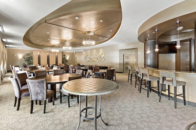 dining room featuring carpet flooring, a raised ceiling, and recessed lighting