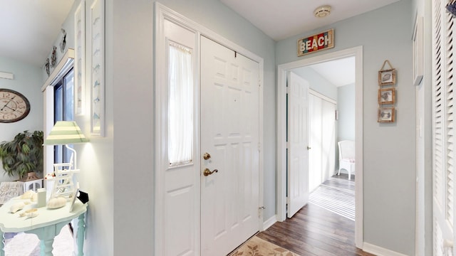 entryway with wood finished floors and baseboards