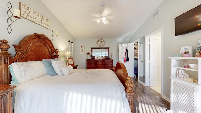 bedroom featuring vaulted ceiling, wood finished floors, visible vents, and a ceiling fan