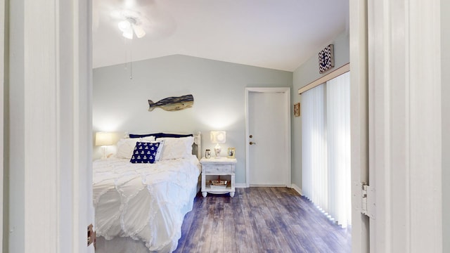 bedroom featuring a ceiling fan, lofted ceiling, baseboards, and wood finished floors