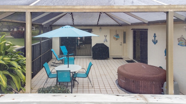 view of patio with glass enclosure