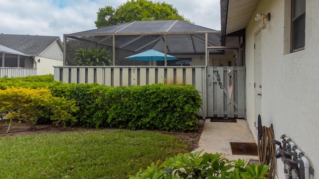 view of yard with glass enclosure