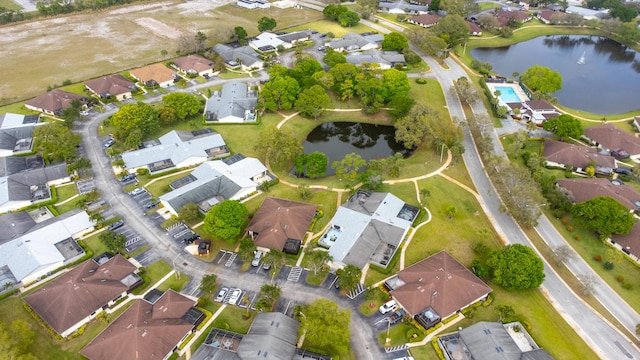 birds eye view of property with a water view and a residential view