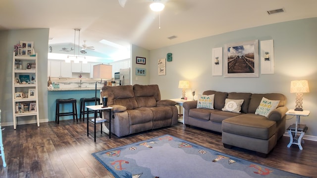 living area with dark wood-type flooring, lofted ceiling, visible vents, and ceiling fan