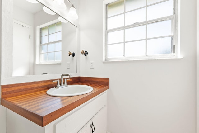 bathroom featuring plenty of natural light and vanity