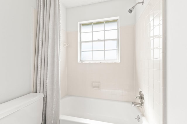 full bath with toilet, shower / tub combo, and a wealth of natural light