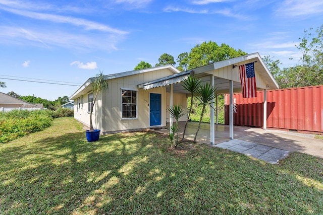 view of front of home with a front yard and fence