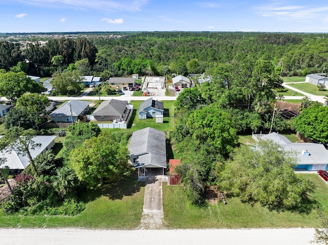 bird's eye view featuring a forest view and a residential view