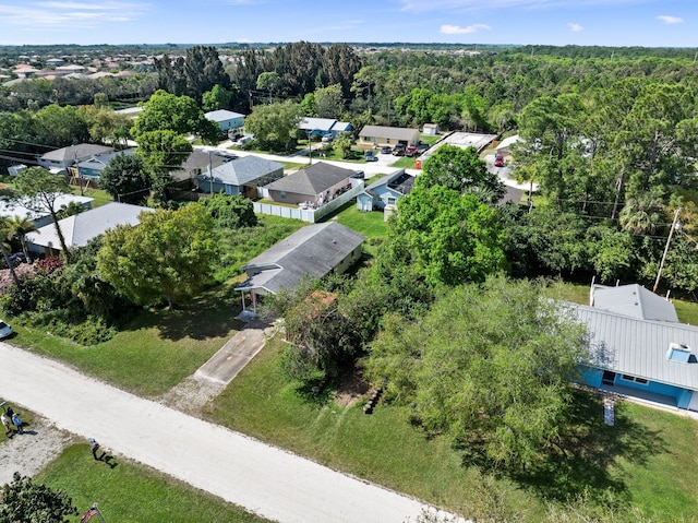 birds eye view of property with a residential view and a view of trees