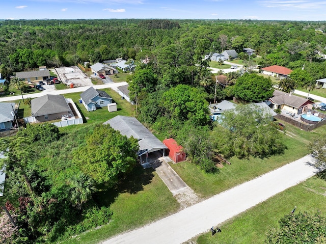 drone / aerial view with a residential view and a view of trees