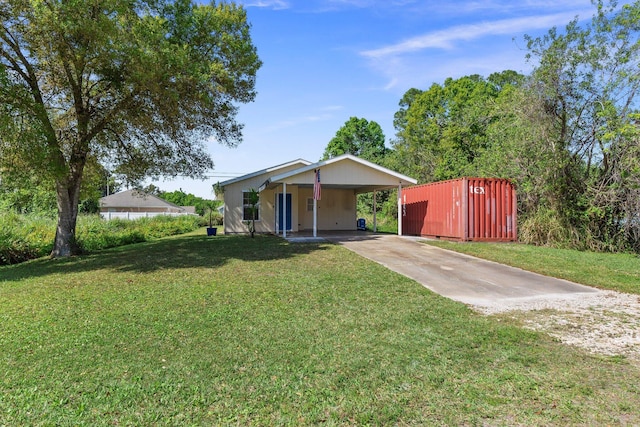 ranch-style house with concrete driveway, an attached carport, and a front yard