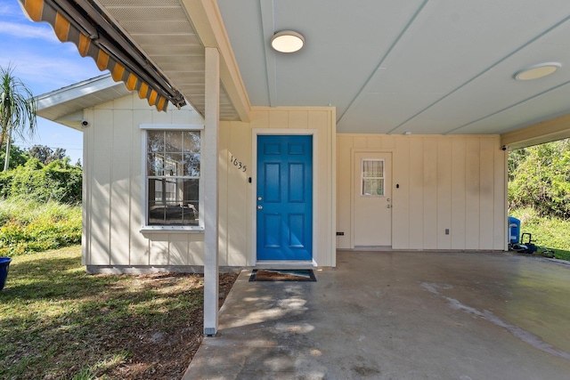 view of exterior entry featuring a carport