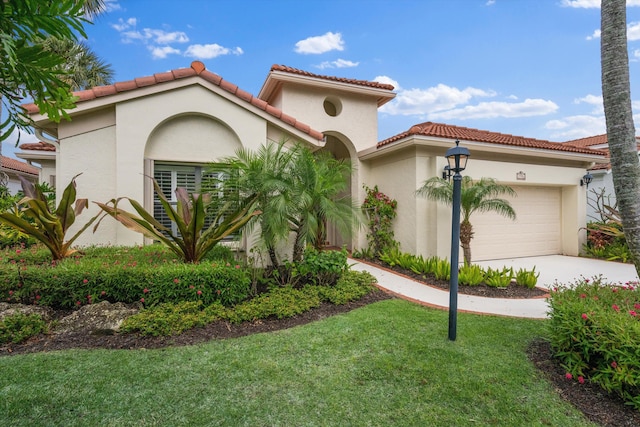 mediterranean / spanish home featuring a garage, a tile roof, concrete driveway, stucco siding, and a front lawn