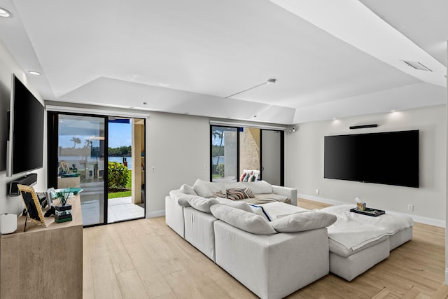 living area with light wood-style floors, recessed lighting, visible vents, and baseboards