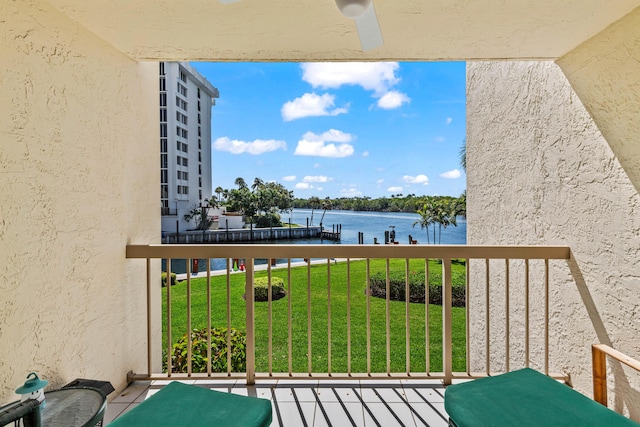 balcony featuring a water view and a dock