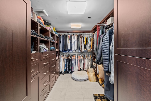 spacious closet featuring light tile patterned floors