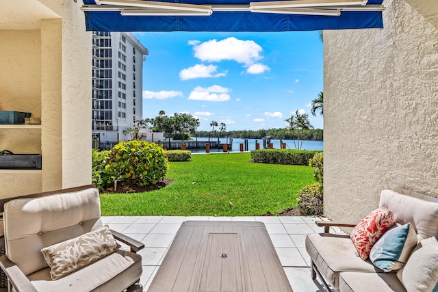 view of patio / terrace featuring a water view and an outdoor living space