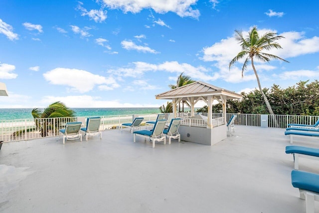 view of patio / terrace featuring a water view and a gazebo