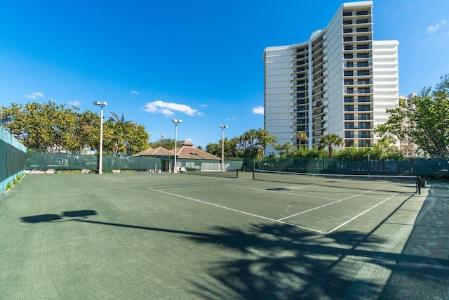 view of tennis court with fence