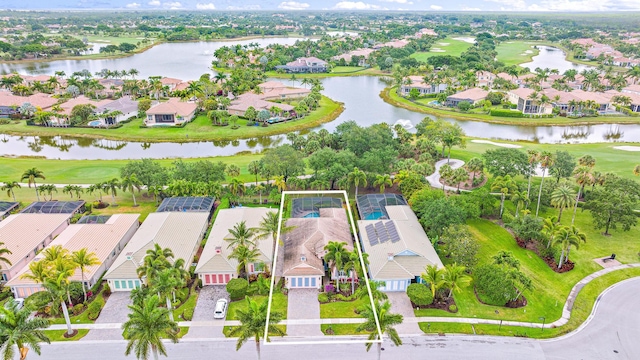 aerial view with a residential view, view of golf course, and a water view