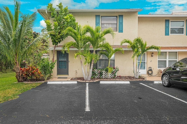 multi unit property with uncovered parking and stucco siding