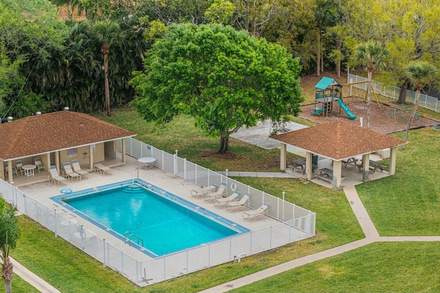 pool with a patio, playground community, fence, a yard, and a gazebo