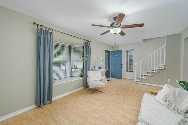 interior space with stairway, plenty of natural light, wood finished floors, and baseboards