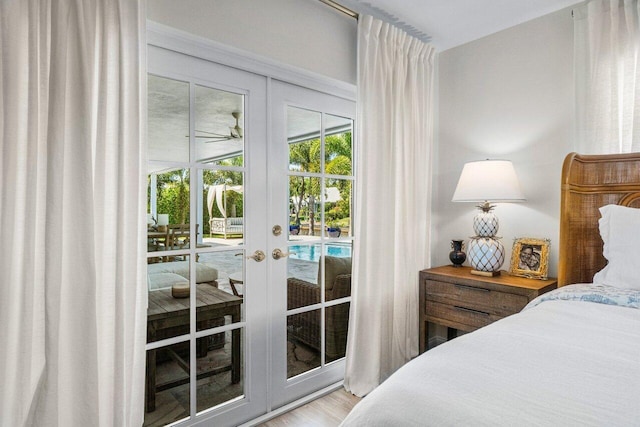 bedroom featuring french doors, wood finished floors, and access to outside