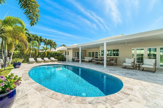 view of pool with french doors, outdoor lounge area, a fenced in pool, ceiling fan, and a patio area