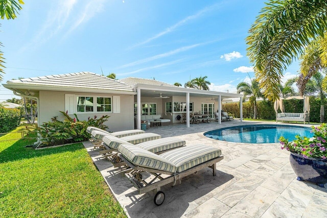 view of pool featuring a lawn, an outdoor living space, fence, a fenced in pool, and a patio area