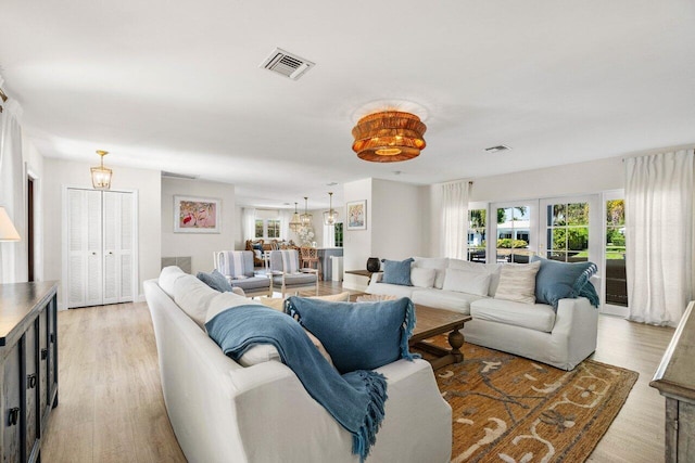 living room featuring visible vents and light wood-type flooring