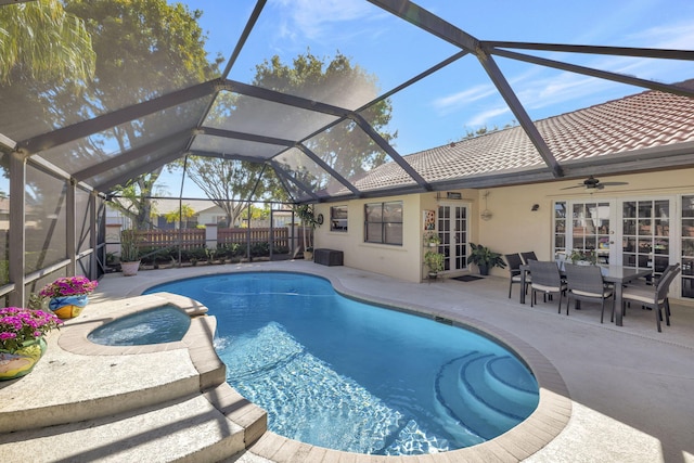 view of pool with a ceiling fan, outdoor dining area, a pool with connected hot tub, fence, and a patio